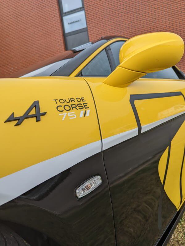 Voiture jaune, logo Alpine Tour de Corse.