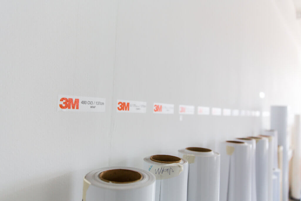 Rouleaux de film adhésif 3M sur étagère.